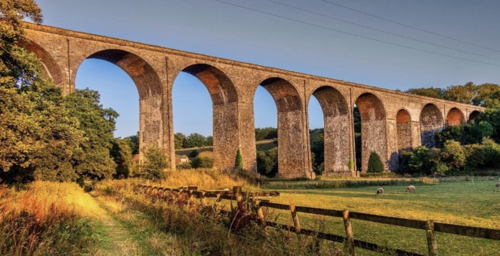 A railway viaduct in golden evening light over the Somerset countryside near Shepton Mallet